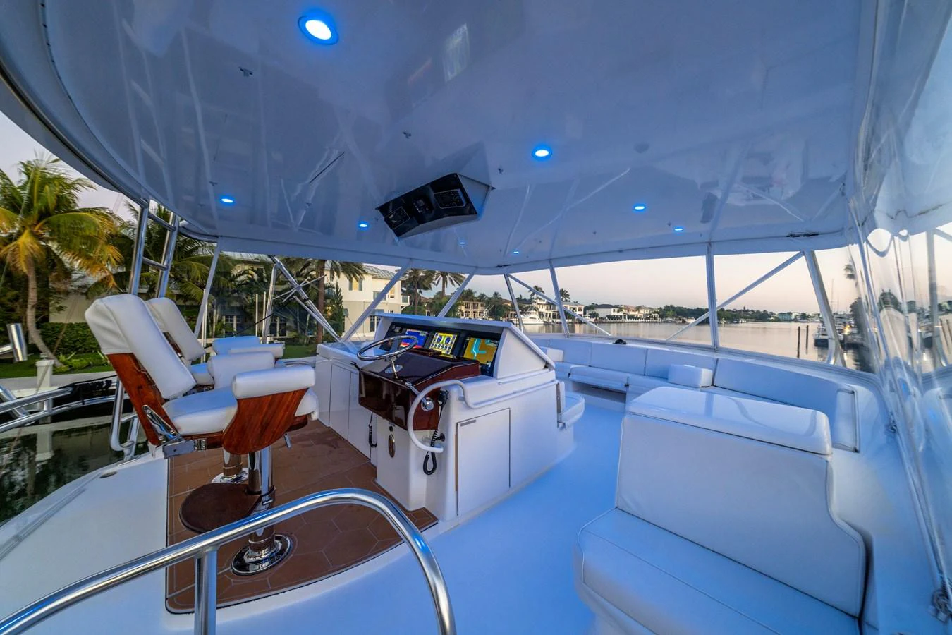 The helm area features modern navigation equipment and comfortable seating under a sleek, covered deck. aboard REEL TEXAN Yacht for Sale