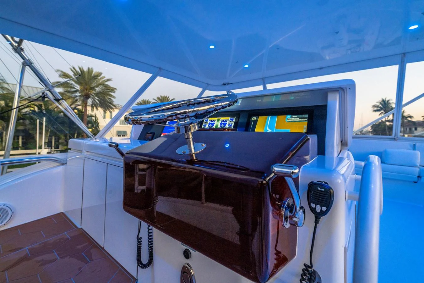 The helm station features advanced navigation equipment and a sleek steering wheel. aboard REEL TEXAN Yacht for Sale