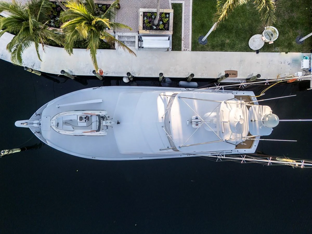 Aerial view of a sleek yacht docked at a marina, showcasing its streamlined design and spacious deck. aboard REEL TEXAN Yacht for Sale