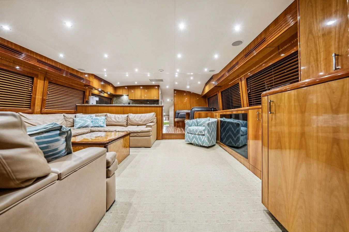 The yacht's salon features comfortable seating and elegant wooden cabinetry. aboard REEL TEXAN Yacht for Sale