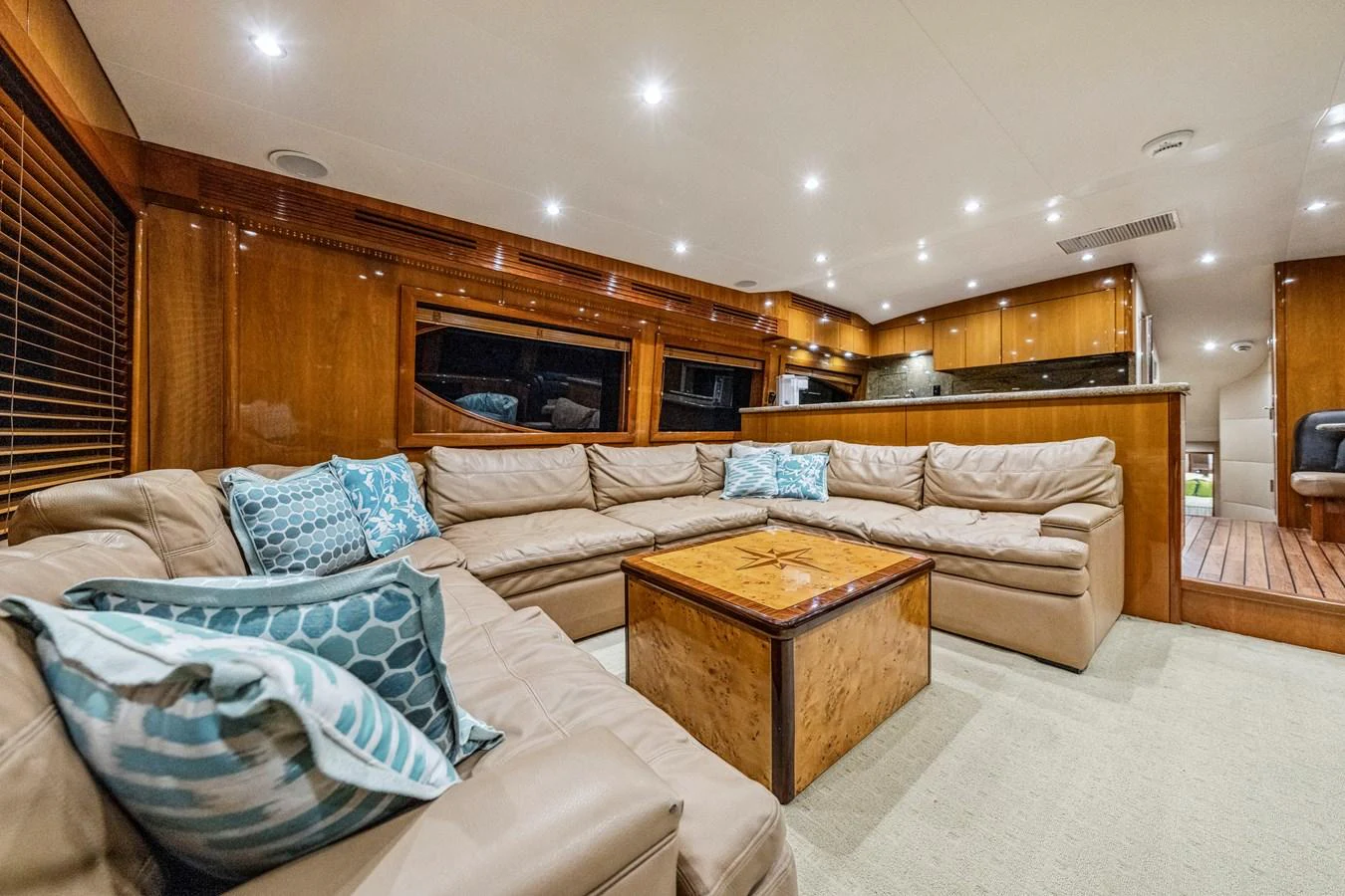 The spacious salon features plush seating and elegant wooden finishes, creating a warm and inviting atmosphere. aboard REEL TEXAN Yacht for Sale