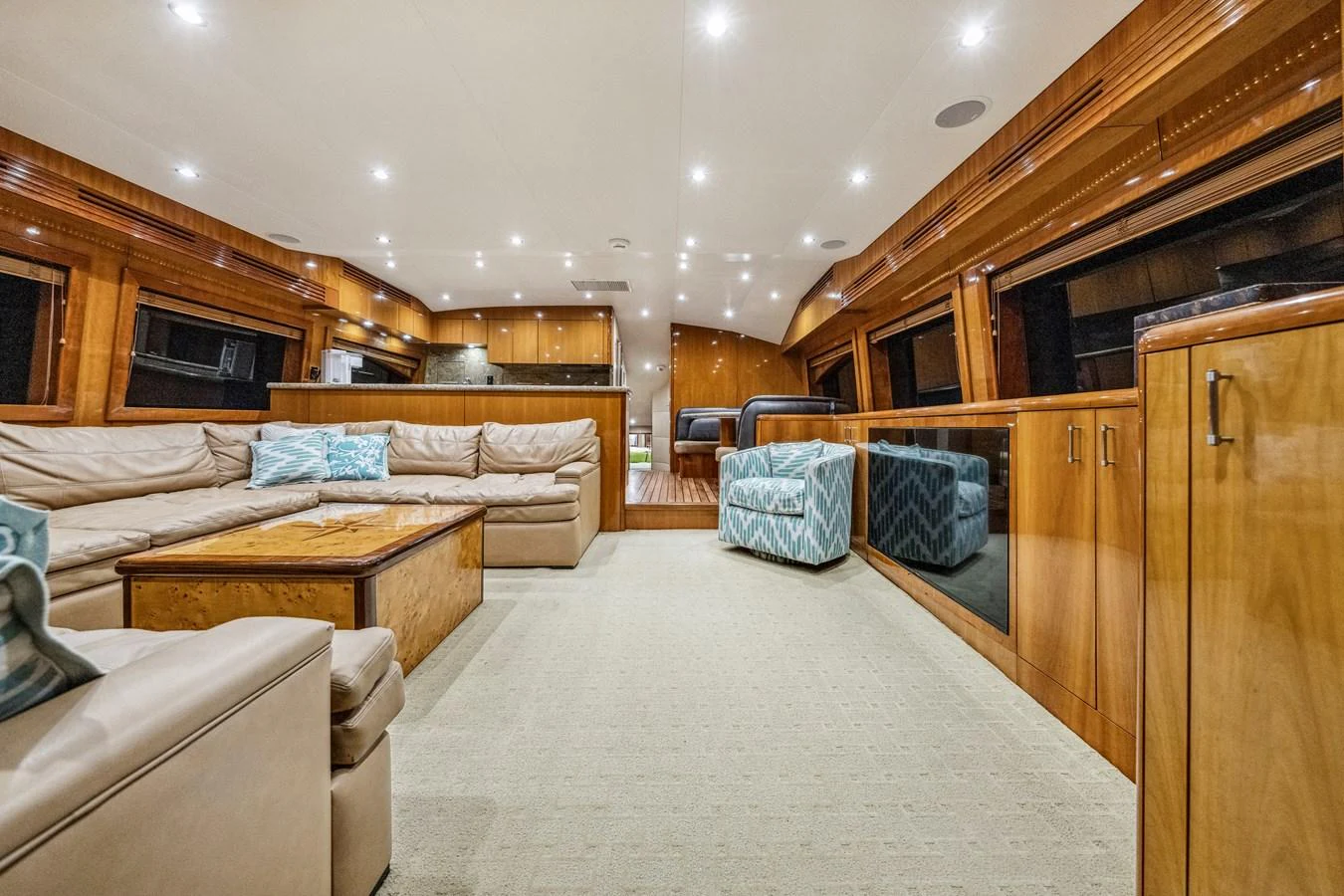 The spacious salon features luxurious seating and elegant wood finishes, creating a warm and inviting atmosphere. aboard REEL TEXAN Yacht for Sale