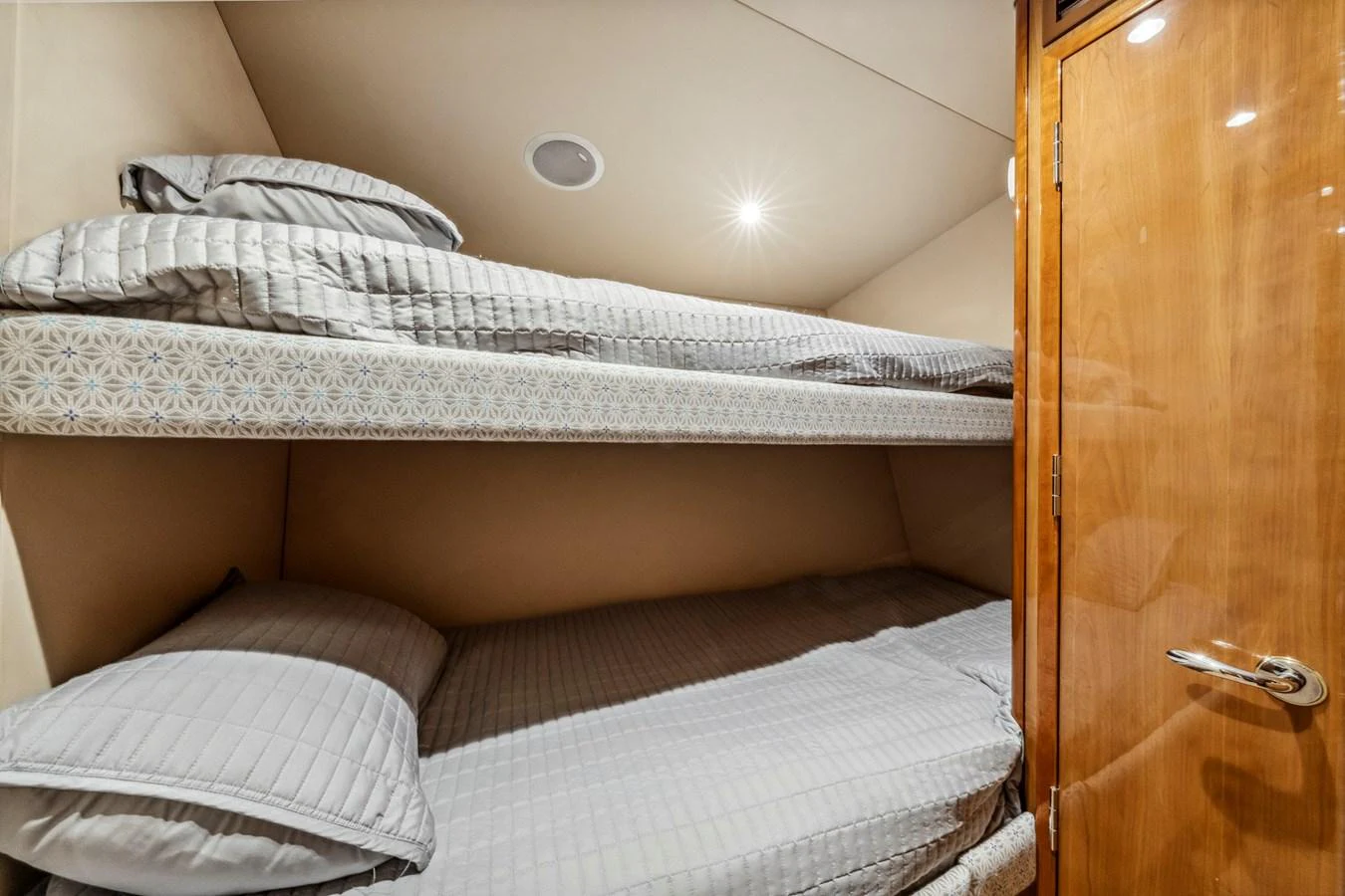 A cozy bunk cabin with neatly arranged bedding and warm wooden accents. aboard REEL TEXAN Yacht for Sale
