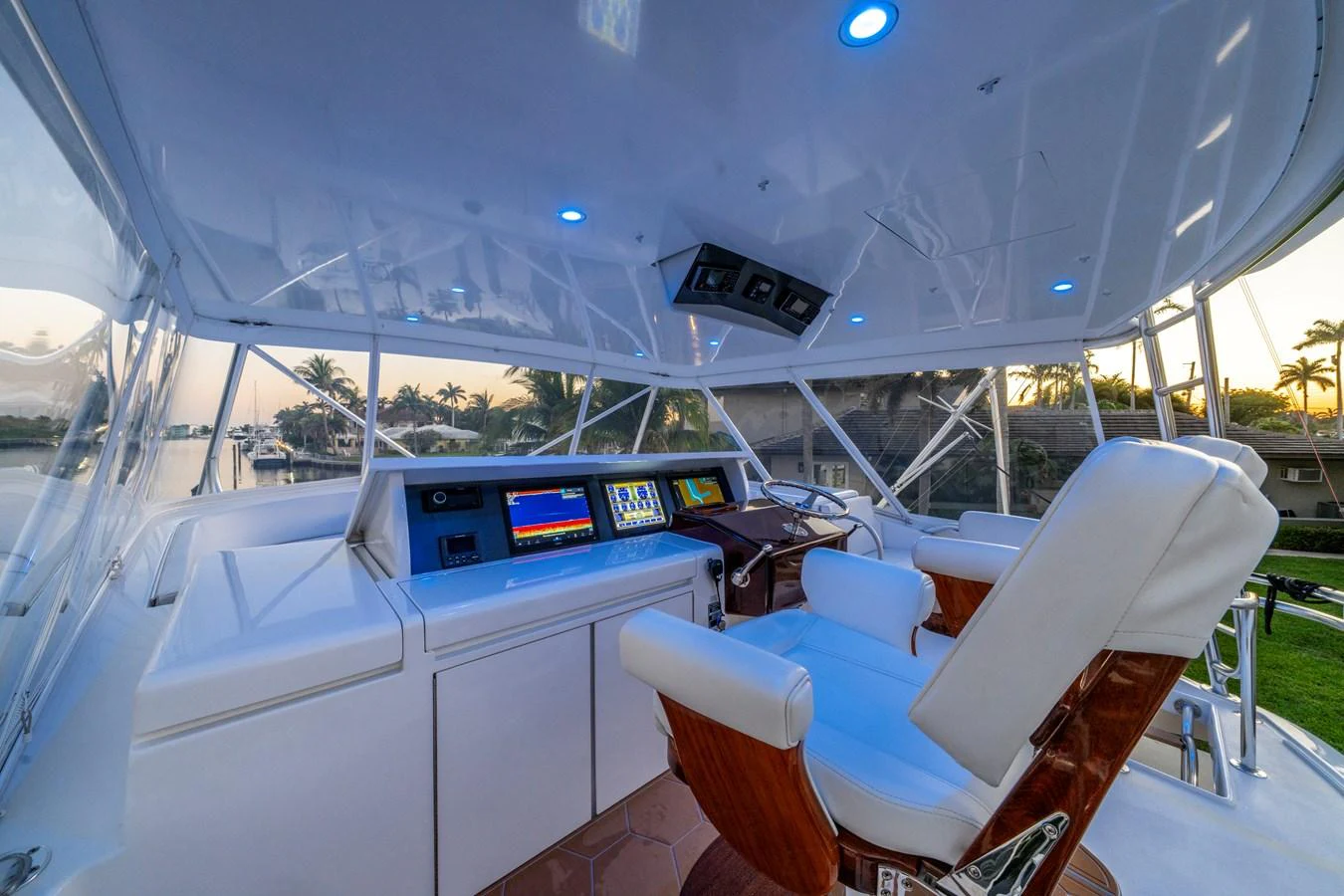 The helm station features state-of-the-art navigation equipment and luxurious seating with a panoramic view. aboard REEL TEXAN Yacht for Sale