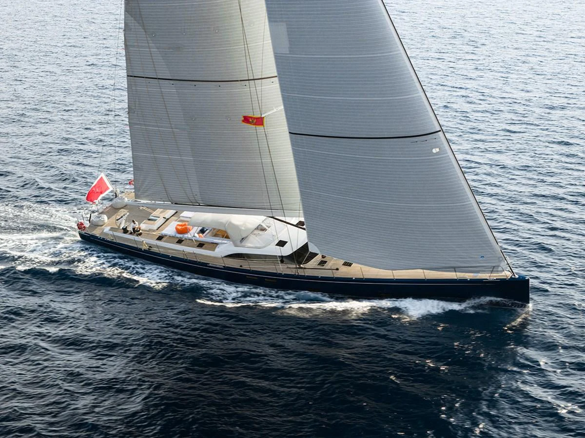 A sleek sailing yacht glides gracefully across the water, showcasing its impressive sails and streamlined design. aboard FARFALLA Yacht for Sale