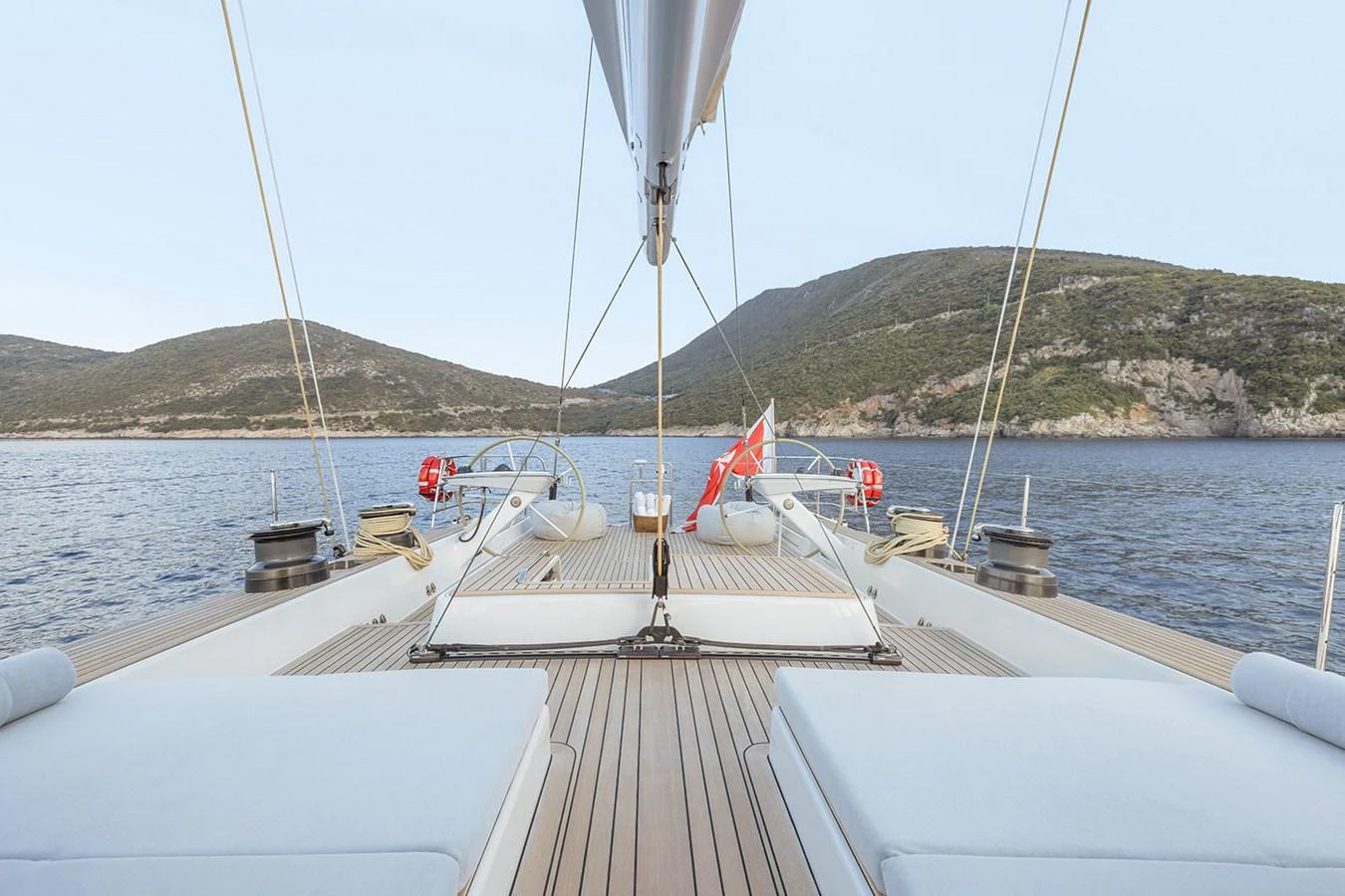 The aft deck offers a serene view of the surrounding waters and hills. aboard FARFALLA Yacht for Sale