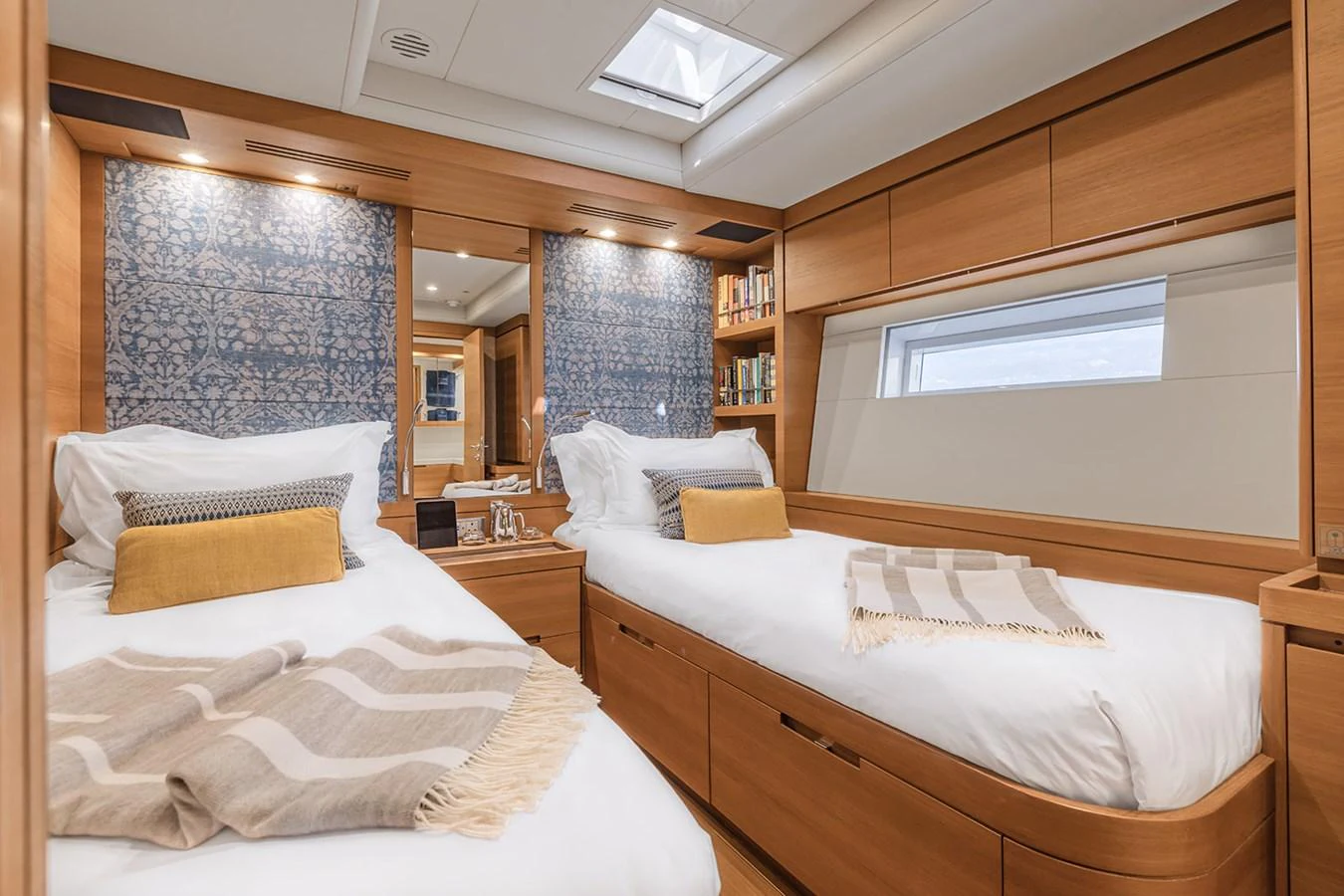 The twin stateroom features two comfortable beds with elegant bedding and ample natural light. aboard FARFALLA Yacht for Sale