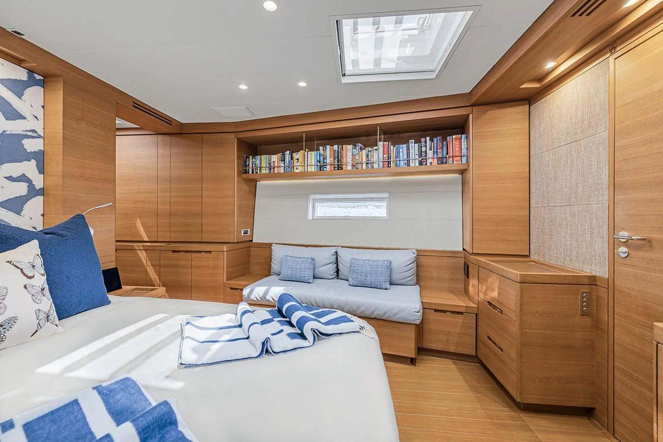 The stateroom features elegant wood paneling, a cozy seating area, and ample storage space. aboard FARFALLA Yacht for Sale