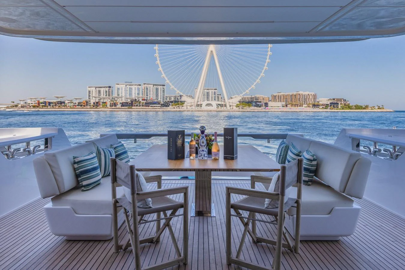 The aft deck offers a luxurious dining area with a stunning waterfront view. aboard CYRUS Yacht for Sale