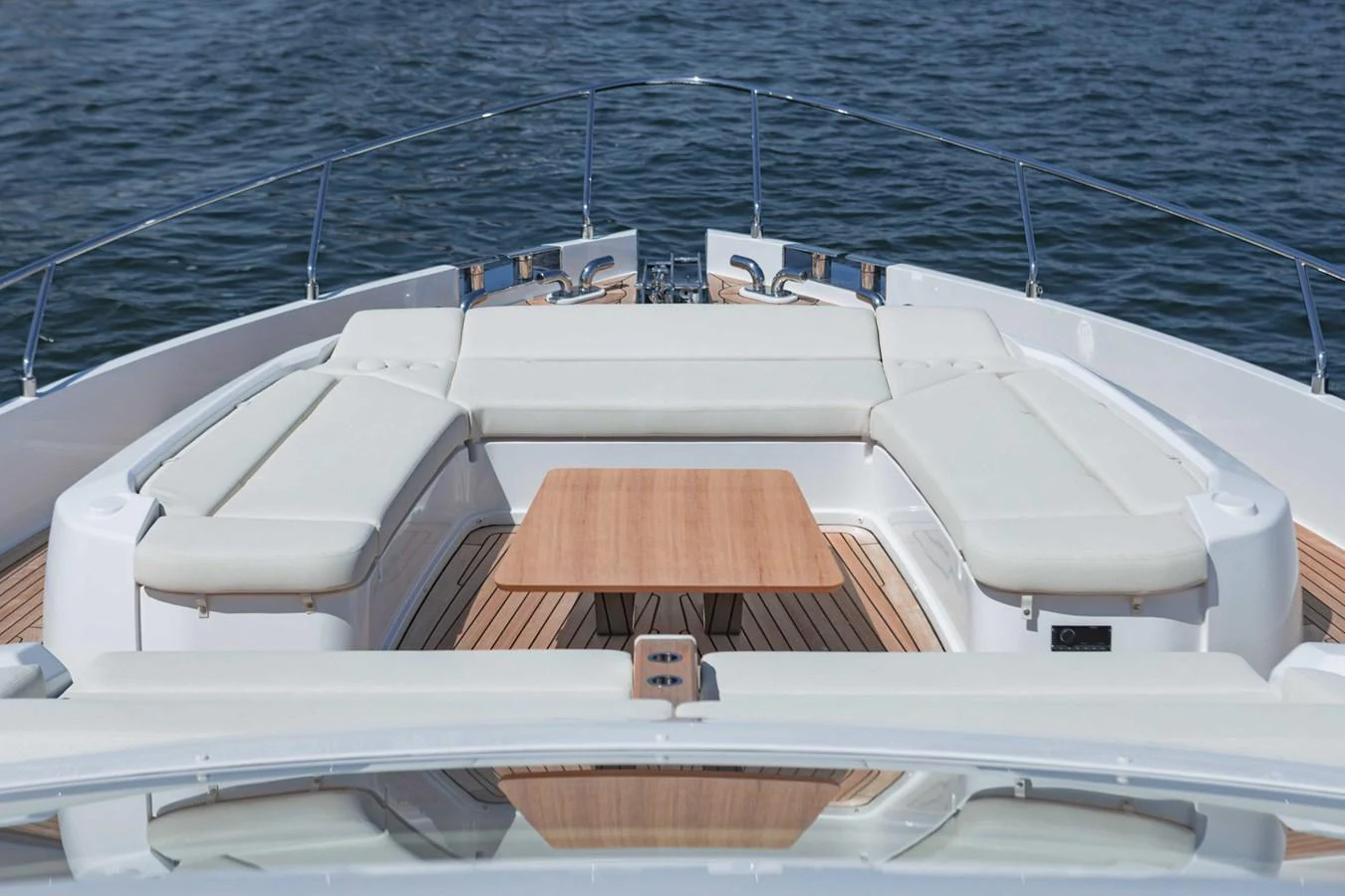 The foredeck features a spacious seating area with a central wooden table, perfect for relaxation and socializing. aboard CYRUS Yacht for Sale