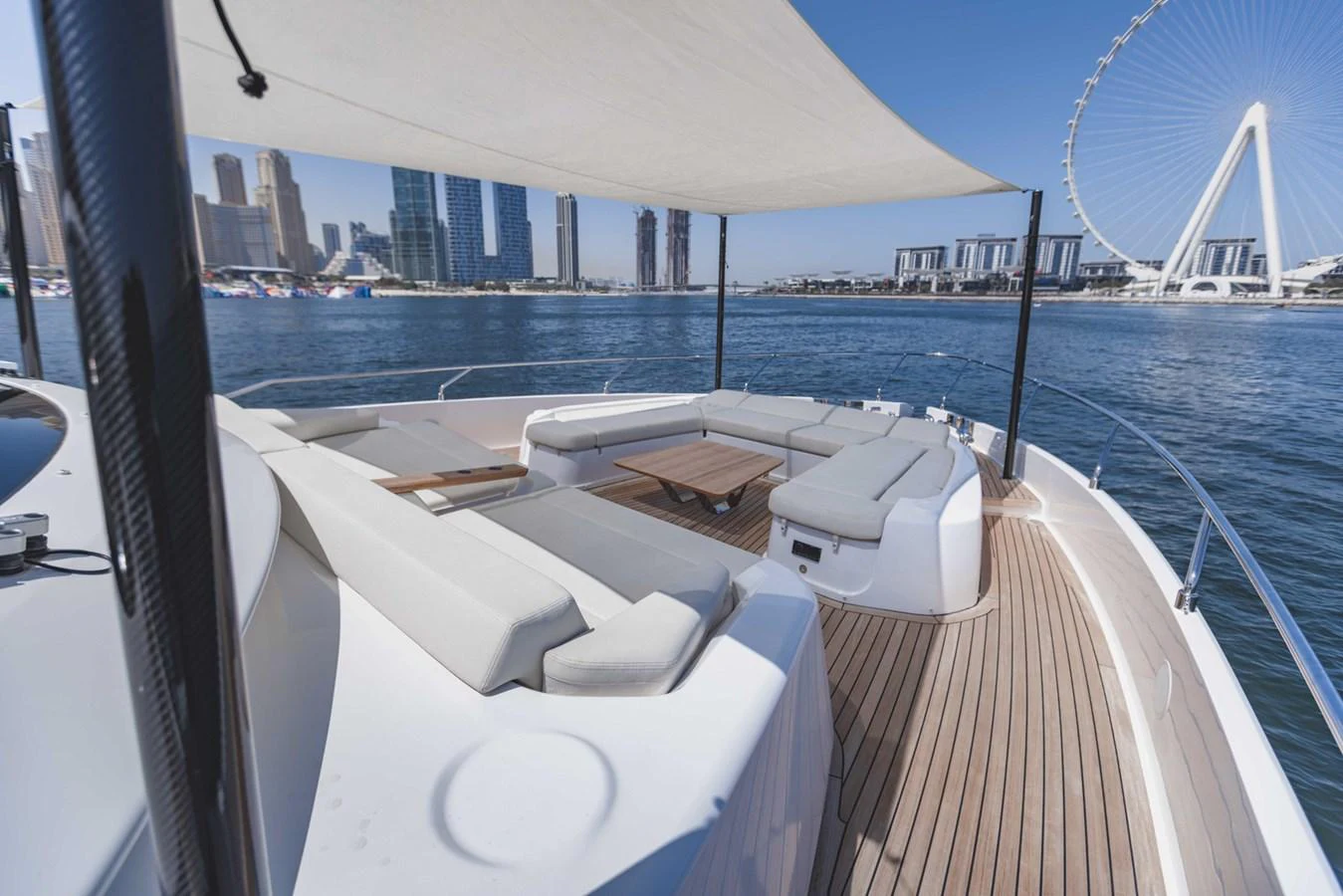 The foredeck features a spacious seating area with a retractable sunshade, offering stunning views of the city skyline. aboard CYRUS Yacht for Sale