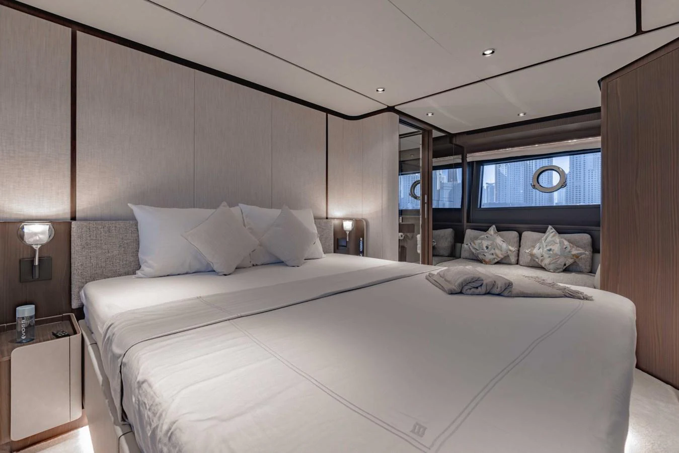 The master stateroom features a spacious bed with elegant bedding and modern lighting. aboard CYRUS Yacht for Sale