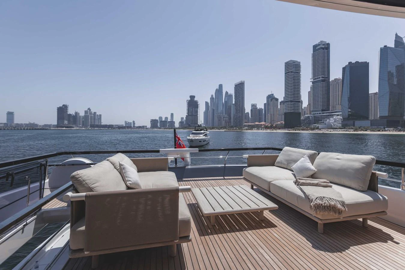 The aft deck offers a luxurious seating area with stunning cityscape views. aboard CYRUS Yacht for Sale