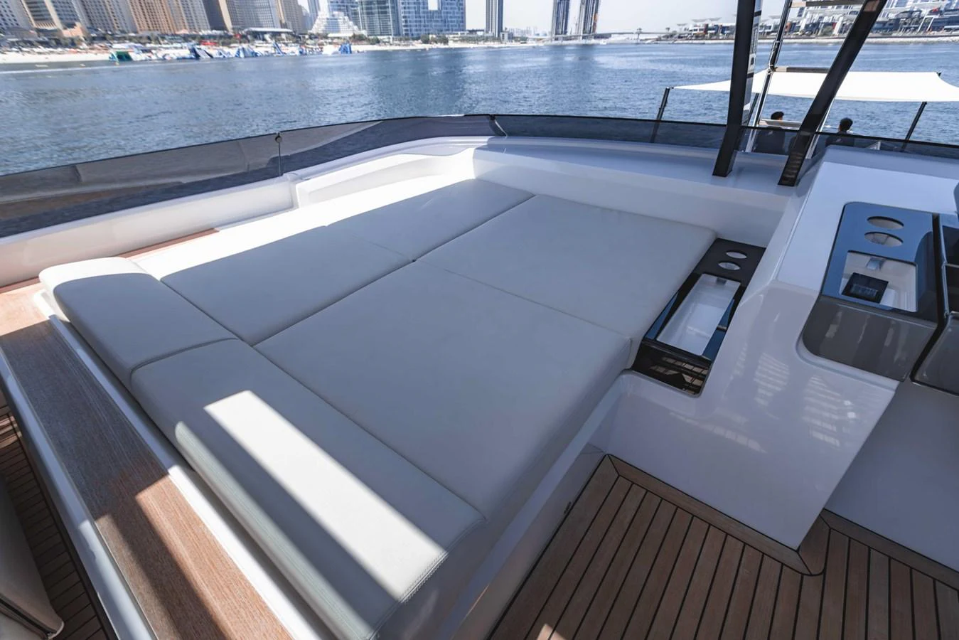 The yacht's sundeck features a spacious sunbathing area with plush cushions and sleek design elements. aboard CYRUS Yacht for Sale