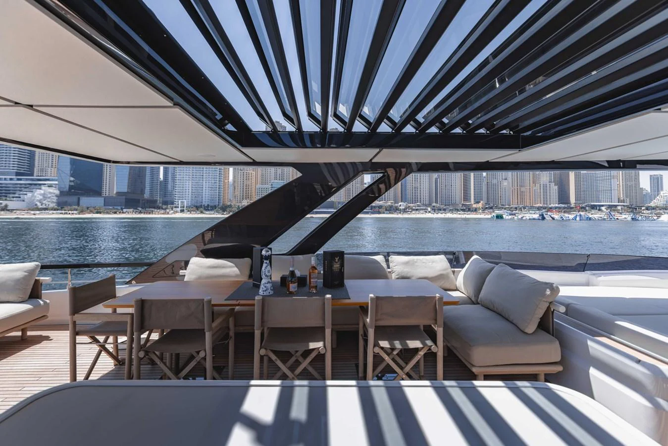 The aft deck features a stylish outdoor dining area with a stunning view of the marina. aboard CYRUS Yacht for Sale