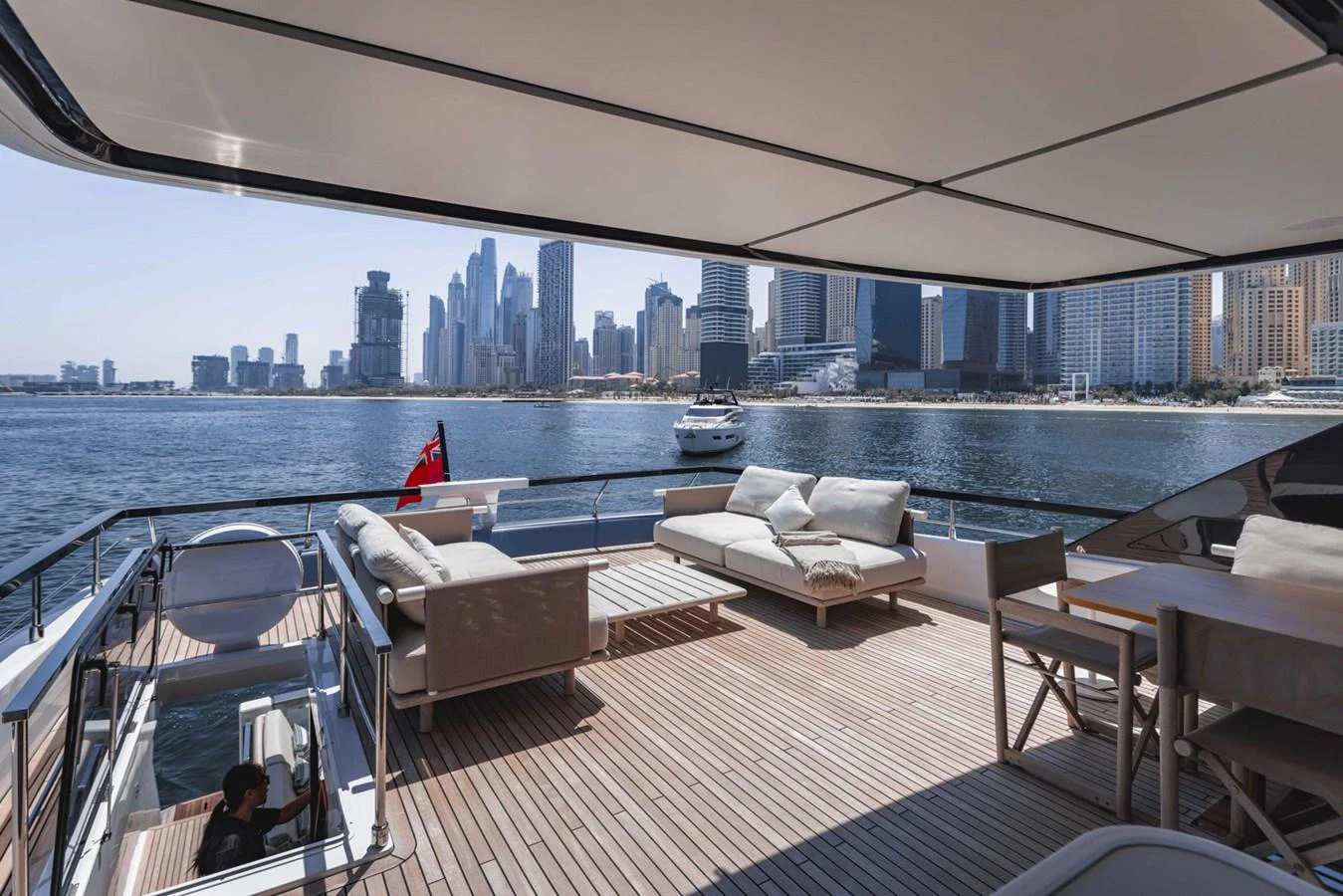 The aft deck offers a spacious and luxurious outdoor lounging area with stunning cityscape views. aboard CYRUS Yacht for Sale