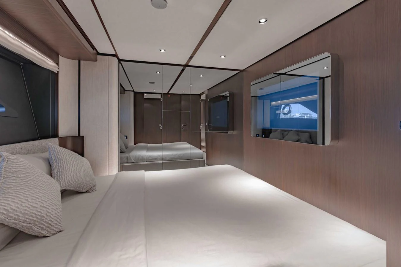 The stateroom features a luxurious bed with modern decor and ample lighting. aboard CYRUS Yacht for Sale