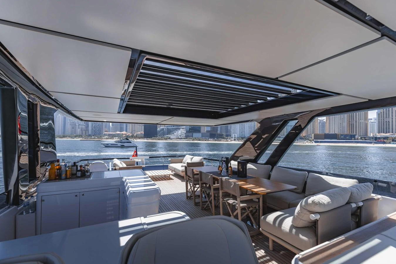 The aft deck offers a spacious and luxurious outdoor seating area with a stunning view of the water. aboard CYRUS Yacht for Sale