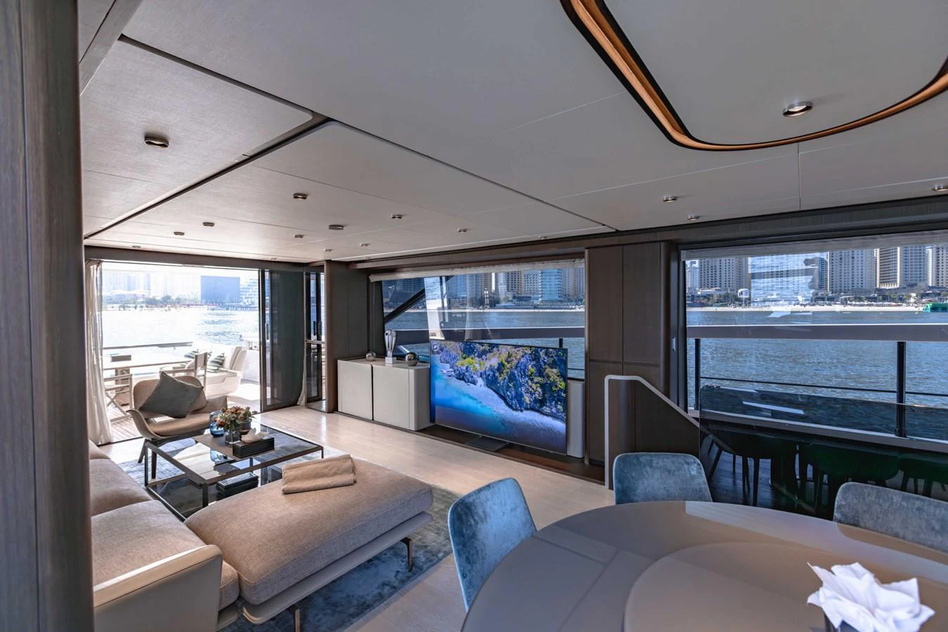 The salon offers a spacious and modern living area with large windows providing stunning views. aboard CYRUS Yacht for Sale