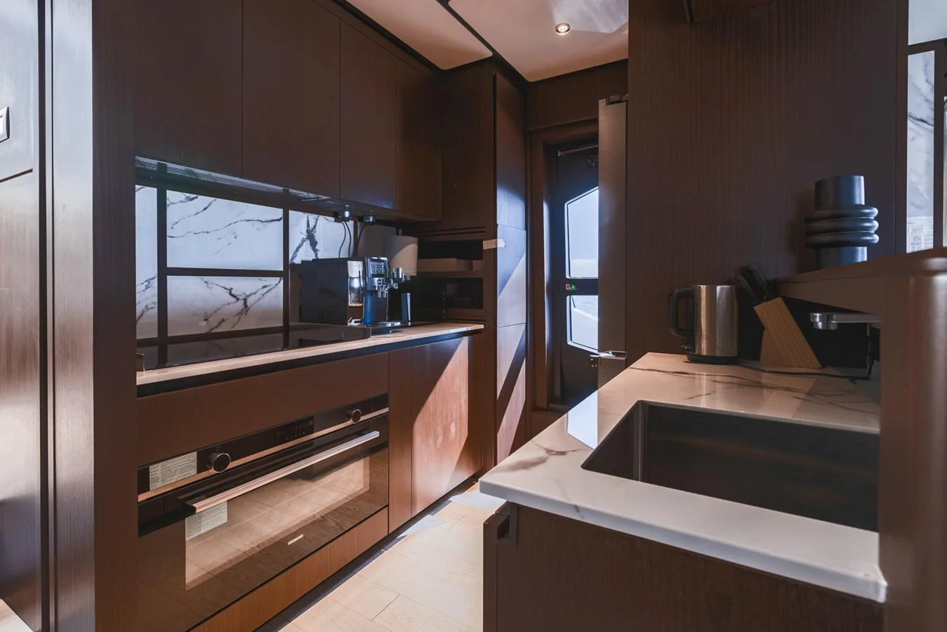 The yacht's galley features modern appliances and sleek cabinetry, creating a sophisticated culinary space. aboard CYRUS Yacht for Sale