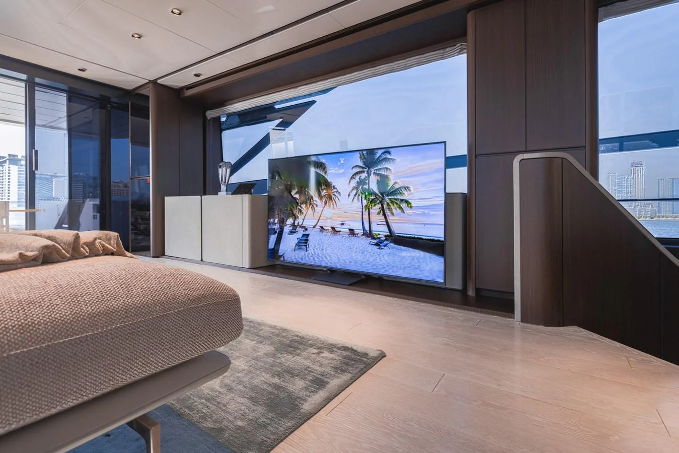 The yacht's interior features a spacious and modern living area with a large flat-screen TV and panoramic windows. aboard CYRUS Yacht for Sale