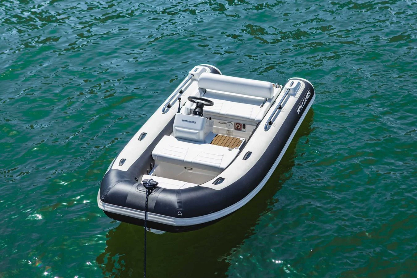 A sleek and modern tender floats on calm waters, ready for quick and convenient transport. aboard CYRUS Yacht for Sale