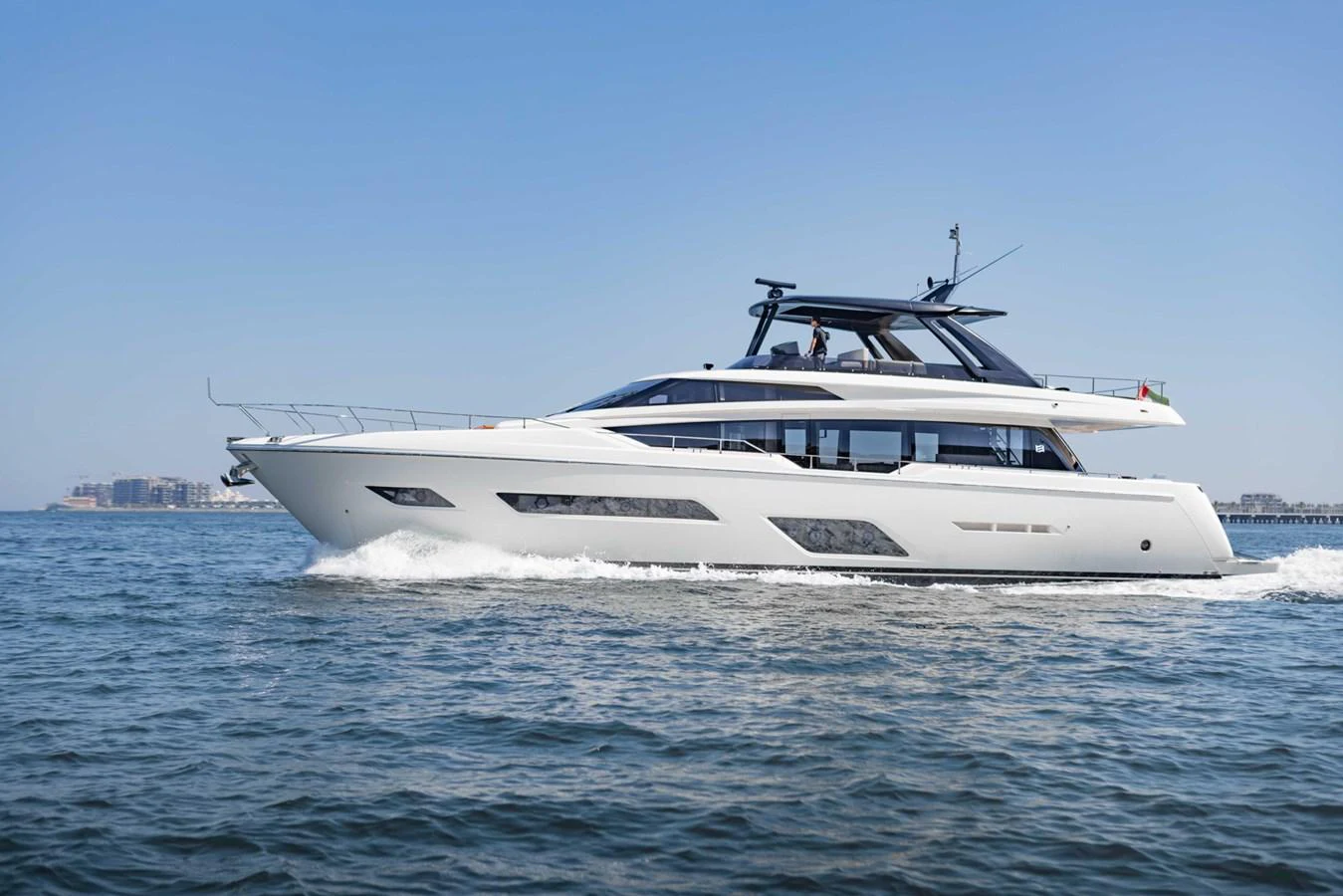 A sleek and modern yacht cruising on calm waters under a clear blue sky. aboard BELLA III Yacht for Sale