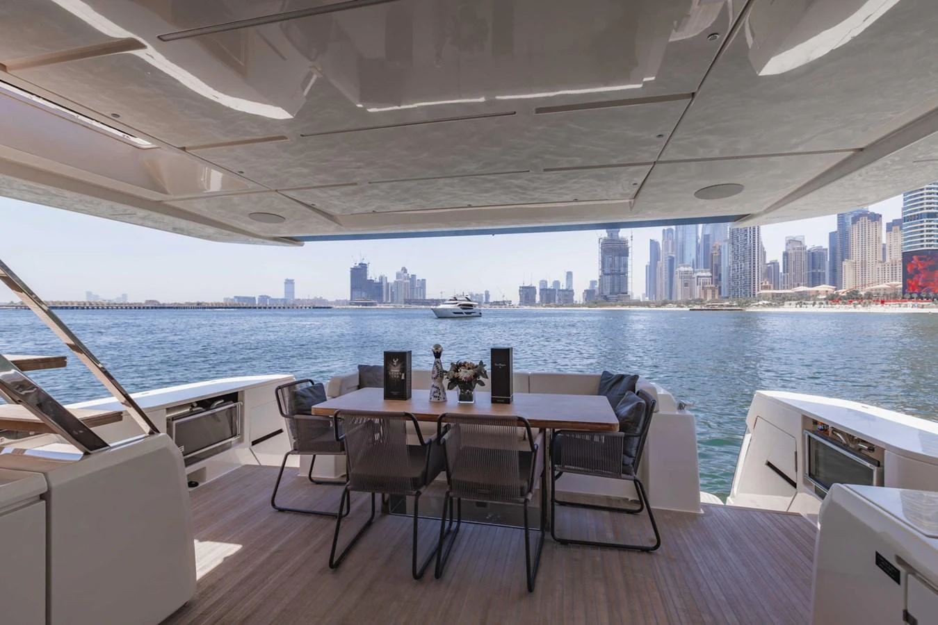 The aft deck offers a spacious dining area with a stunning view of the city skyline. aboard BELLA III Yacht for Sale