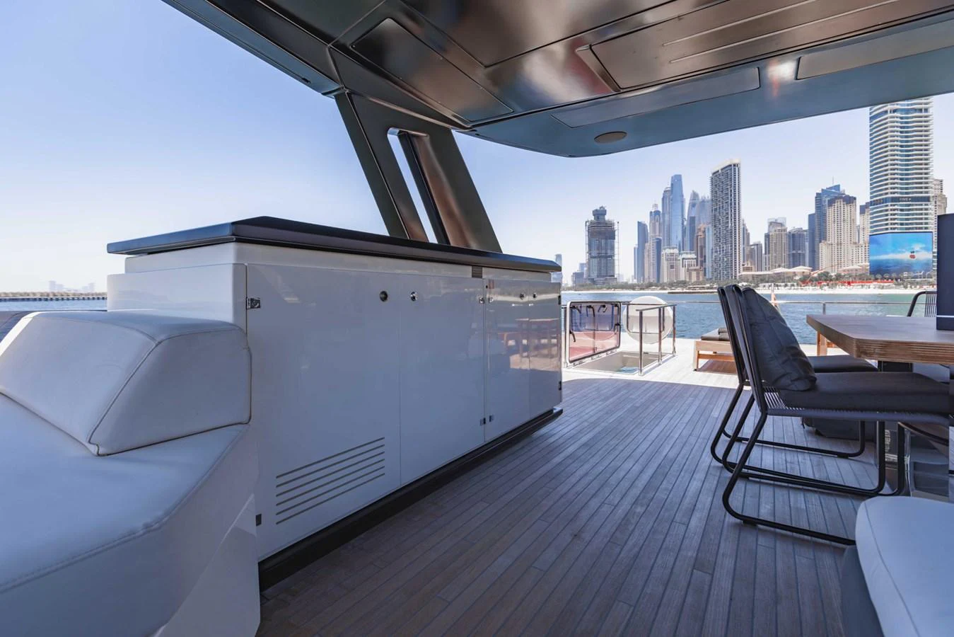 The aft deck offers a spacious and modern outdoor area with stunning city skyline views. aboard BELLA III Yacht for Sale