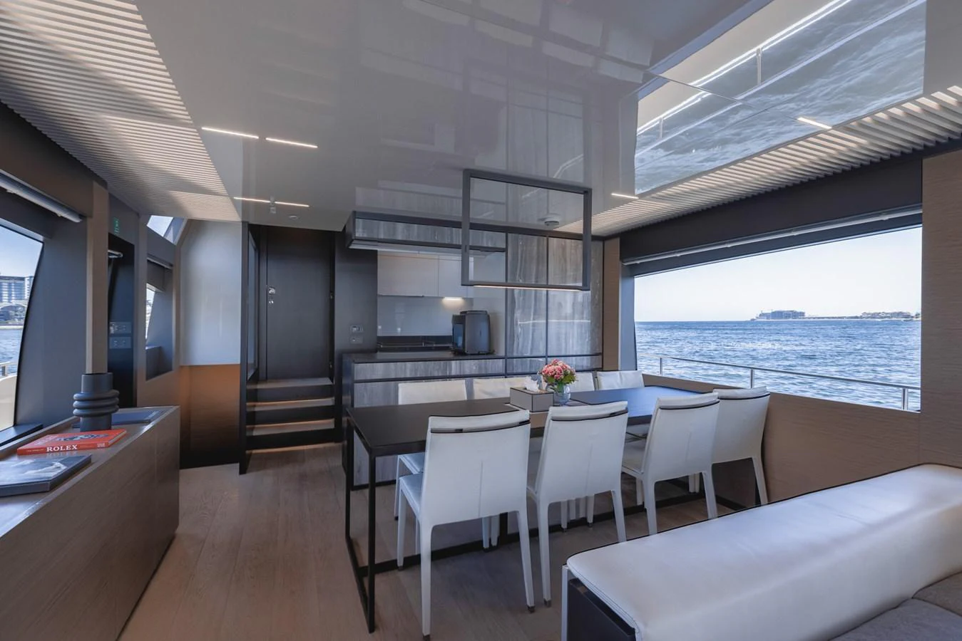 The yacht's dining area offers a modern and elegant setting with panoramic ocean views. aboard BELLA III Yacht for Sale