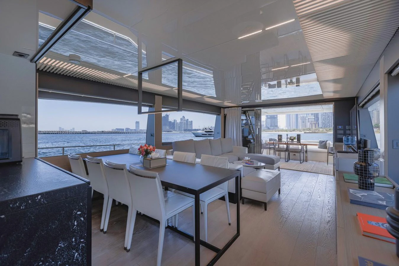 The salon offers a spacious and modern living area with panoramic views of the water and cityscape. aboard BELLA III Yacht for Sale