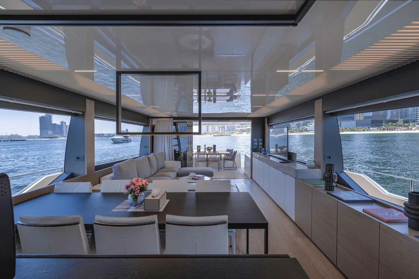 The salon offers a spacious and modern living area with panoramic views of the water. aboard BELLA III Yacht for Sale