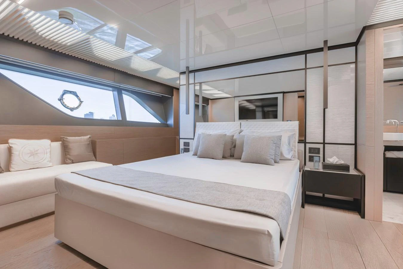 The stateroom features a luxurious bed with modern decor and ample natural light. aboard BELLA III Yacht for Sale