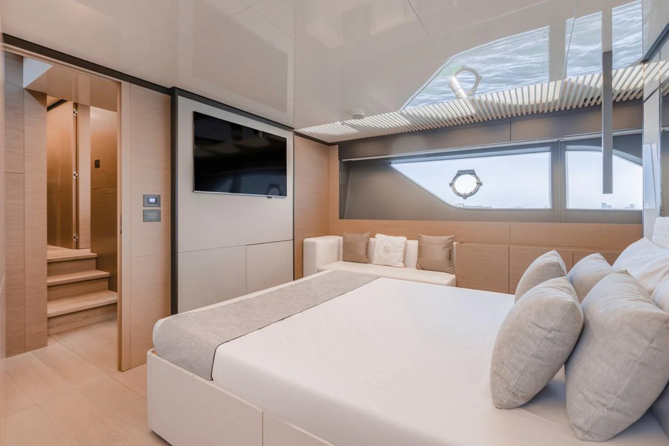 The stateroom features a luxurious bed, modern decor, and ample natural light. aboard BELLA III Yacht for Sale