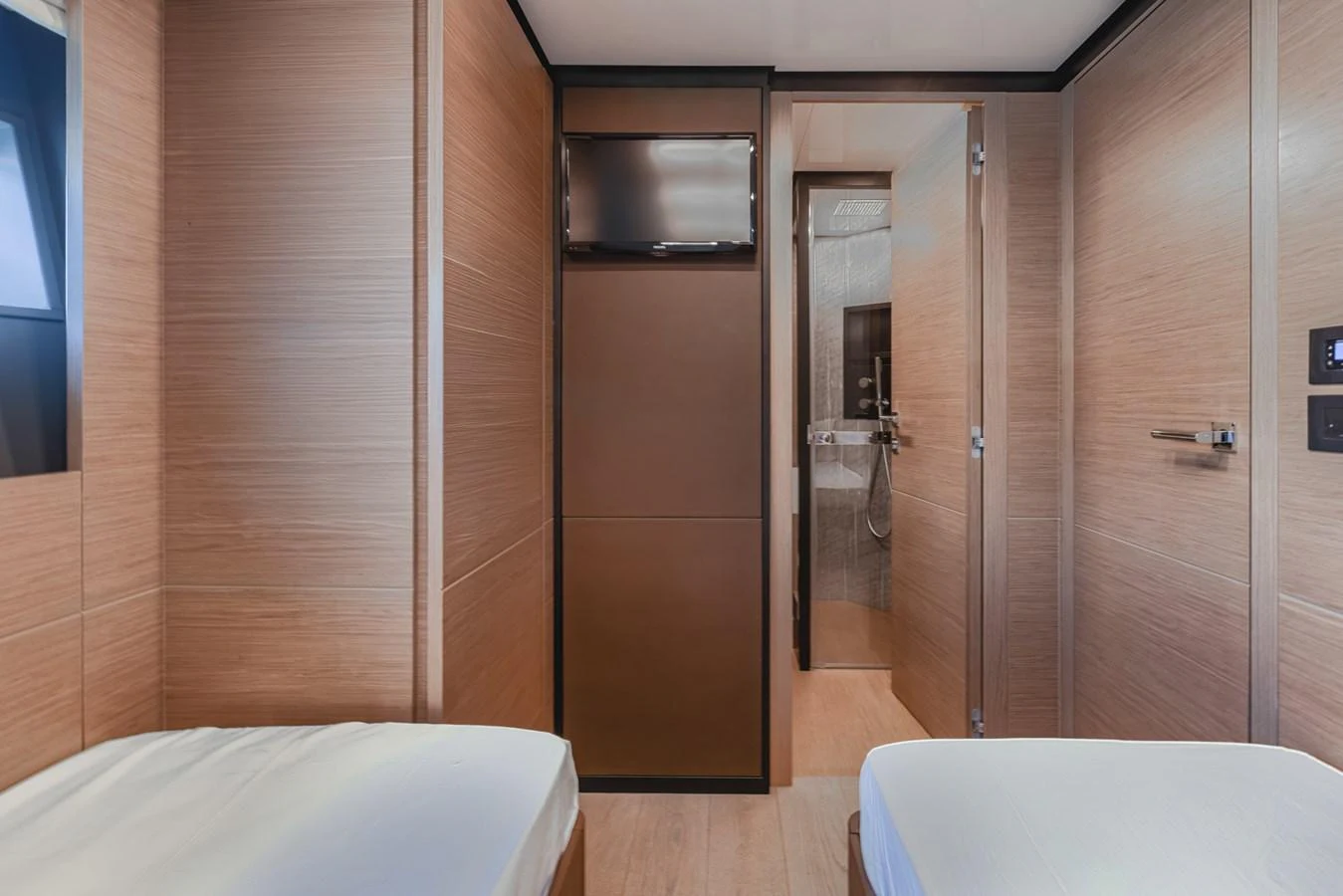 This cozy guest cabin features twin beds and a modern ensuite bathroom. aboard BELLA III Yacht for Sale