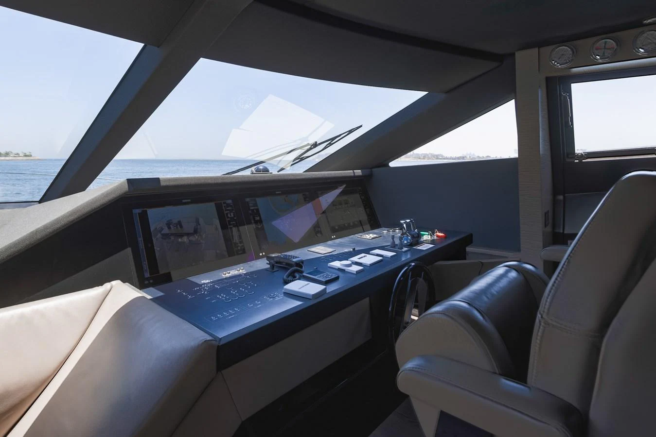 The helm station features advanced navigation equipment and luxurious seating, offering a commanding view of the sea. aboard BELLA III Yacht for Sale
