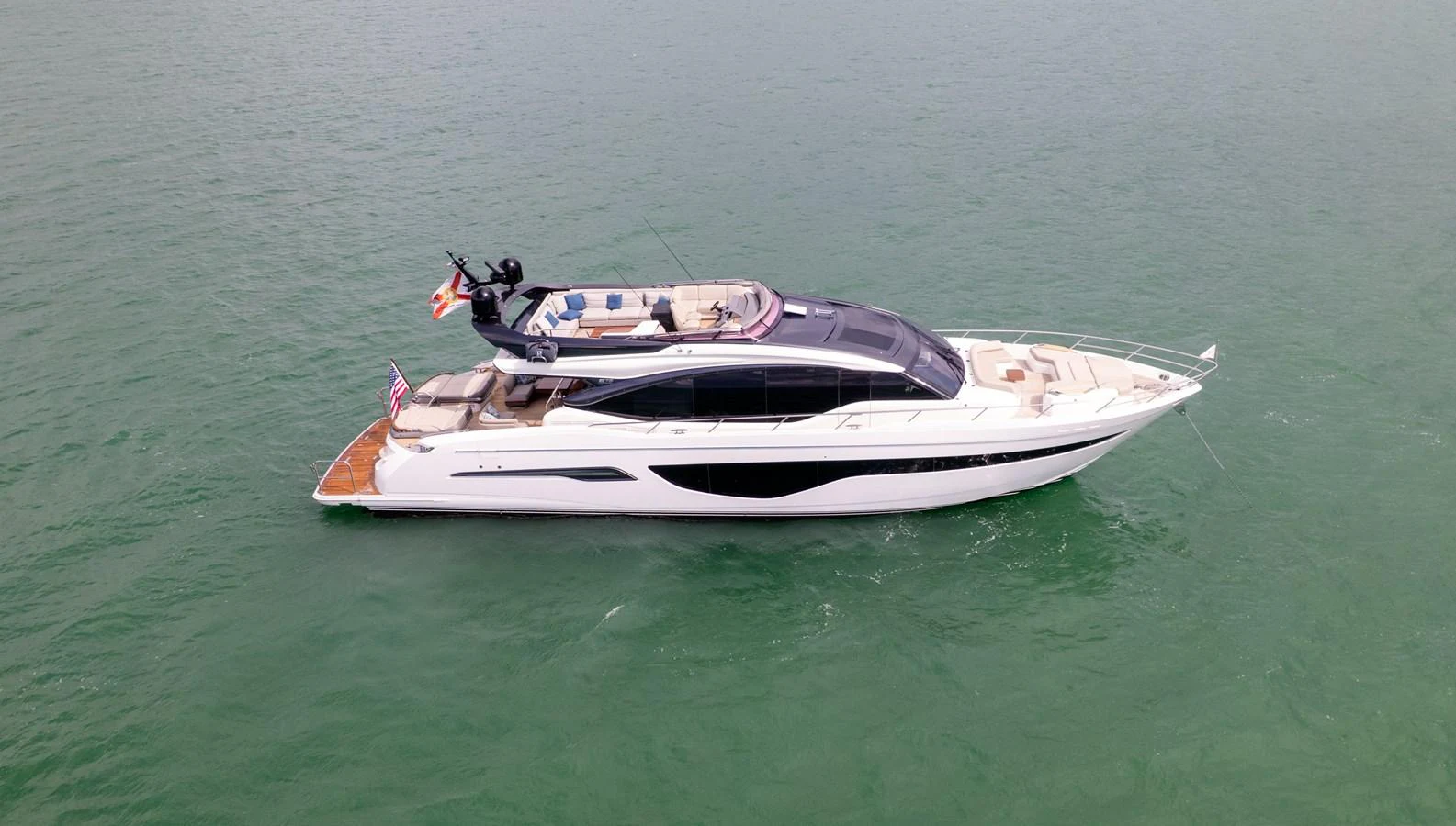 A sleek and modern yacht cruising on calm waters. aboard PARAGON Yacht for Sale