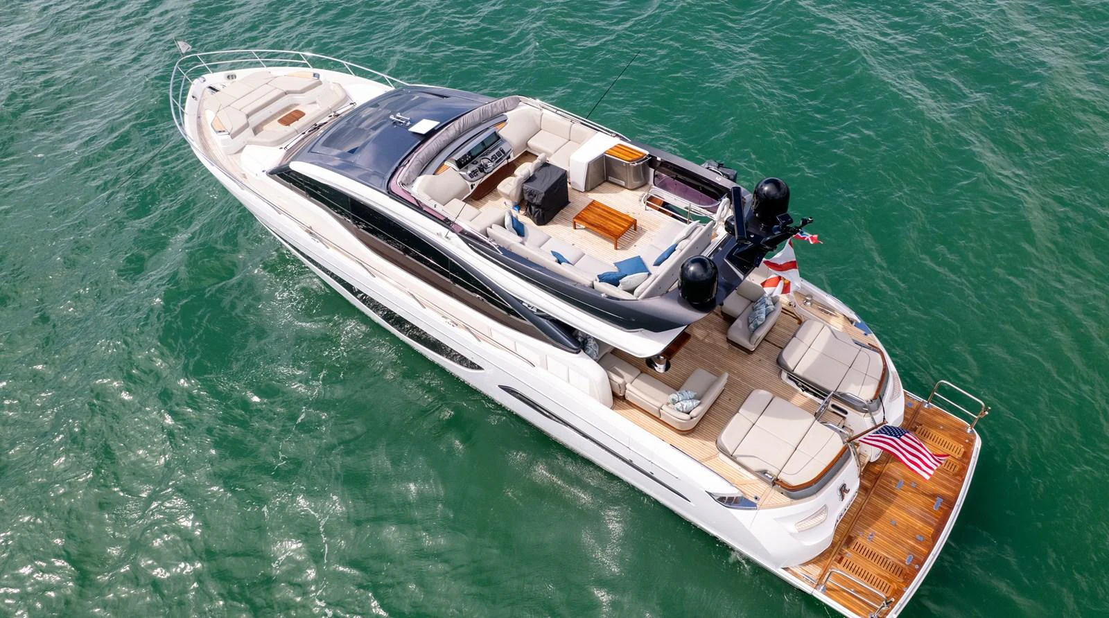 A luxurious yacht cruising on clear waters, showcasing its elegant flybridge and spacious deck areas. aboard PARAGON Yacht for Sale