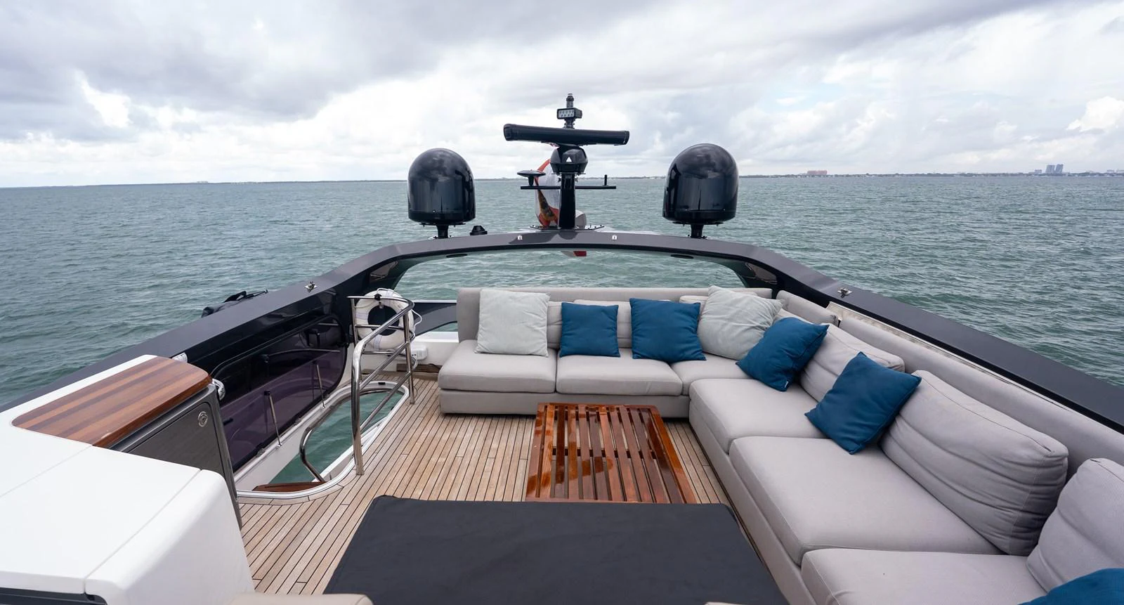 The flybridge features a spacious seating area with plush cushions and a stunning ocean view. aboard PARAGON Yacht for Sale