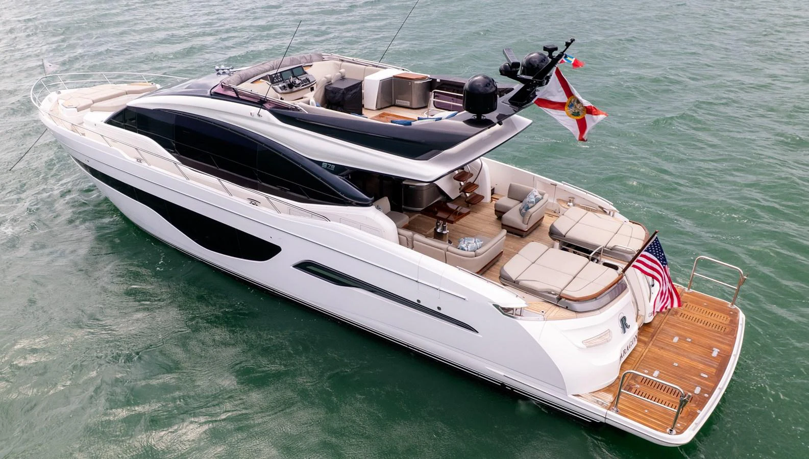 A sleek and modern yacht cruising on the water, showcasing its spacious deck and luxurious amenities. aboard PARAGON Yacht for Sale