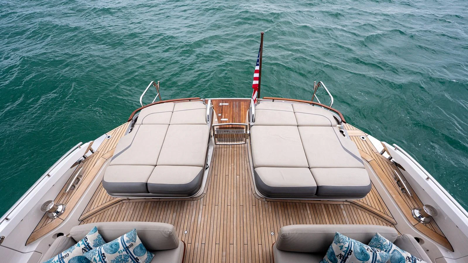 The aft deck features luxurious sun loungers and a view of the open sea. aboard PARAGON Yacht for Sale