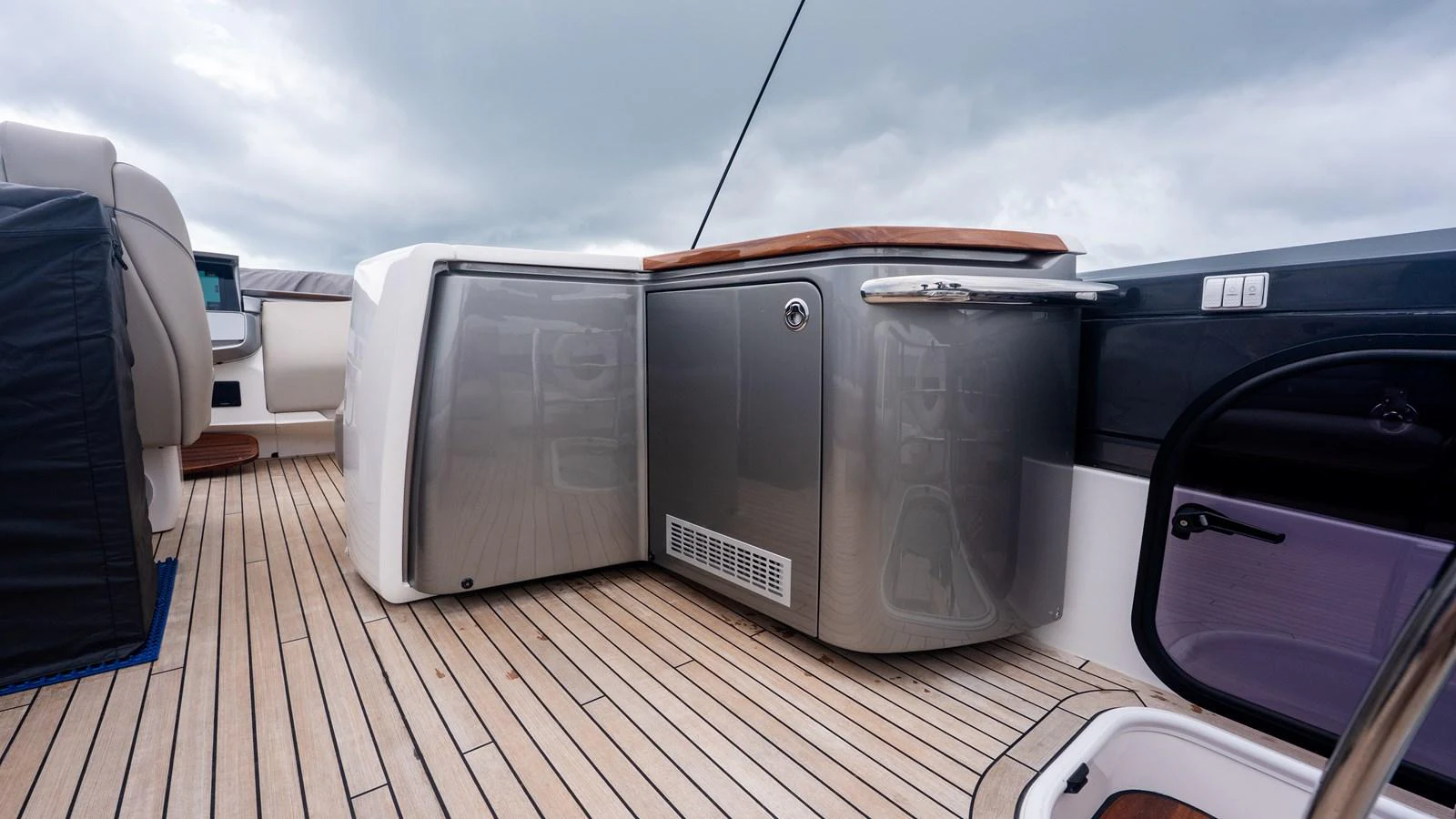 The yacht's galley features sleek cabinetry and modern appliances, set against a backdrop of elegant wooden flooring. aboard PARAGON Yacht for Sale