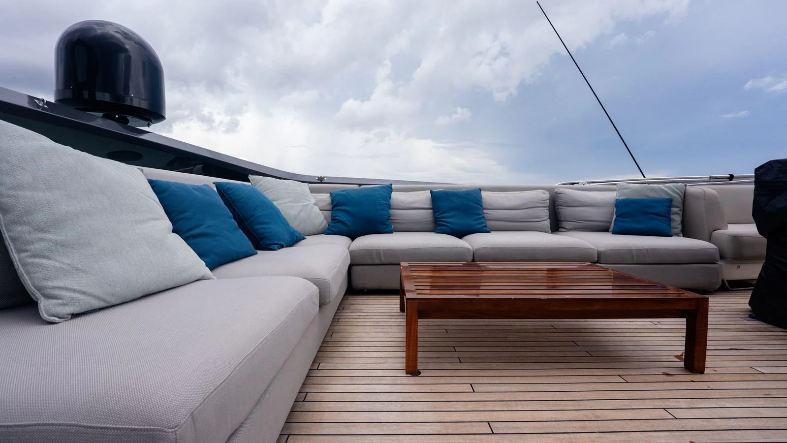 The sundeck features a spacious seating area with plush cushions and a wooden coffee table, perfect for relaxation. aboard PARAGON Yacht for Sale