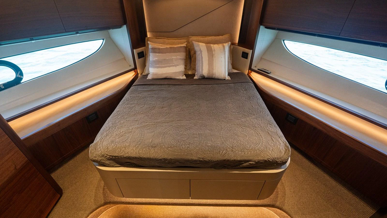 The stateroom features a comfortable double bed with elegant bedding and ample natural light from the side windows. aboard PARAGON Yacht for Sale