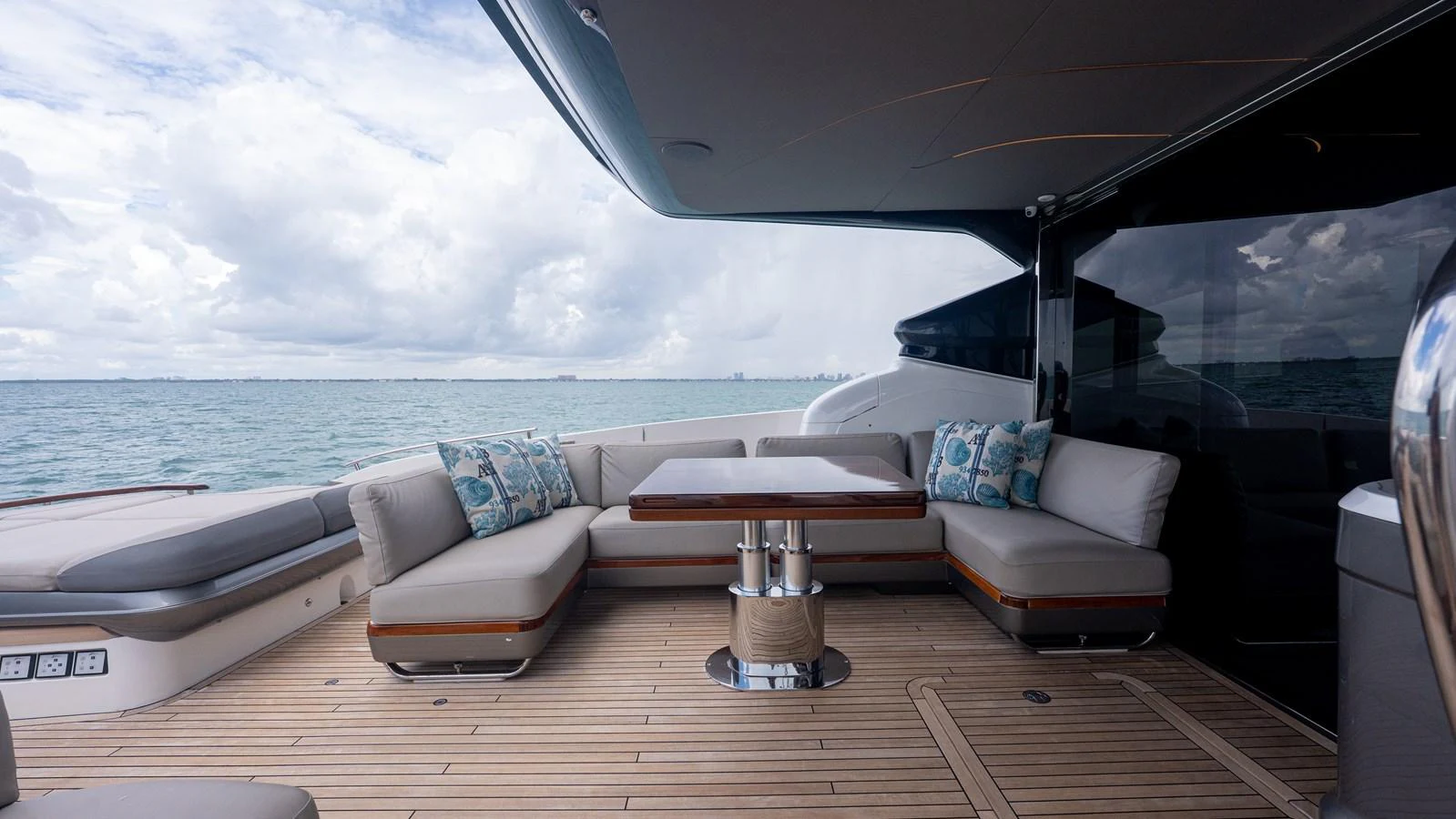 The aft deck features a comfortable seating area with a central table, perfect for outdoor relaxation. aboard PARAGON Yacht for Sale