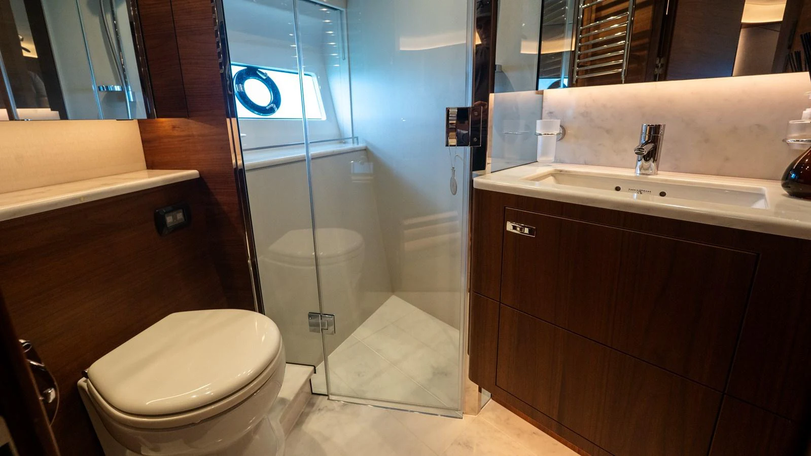 The yacht's bathroom features modern fixtures and elegant wood finishes. aboard PARAGON Yacht for Sale