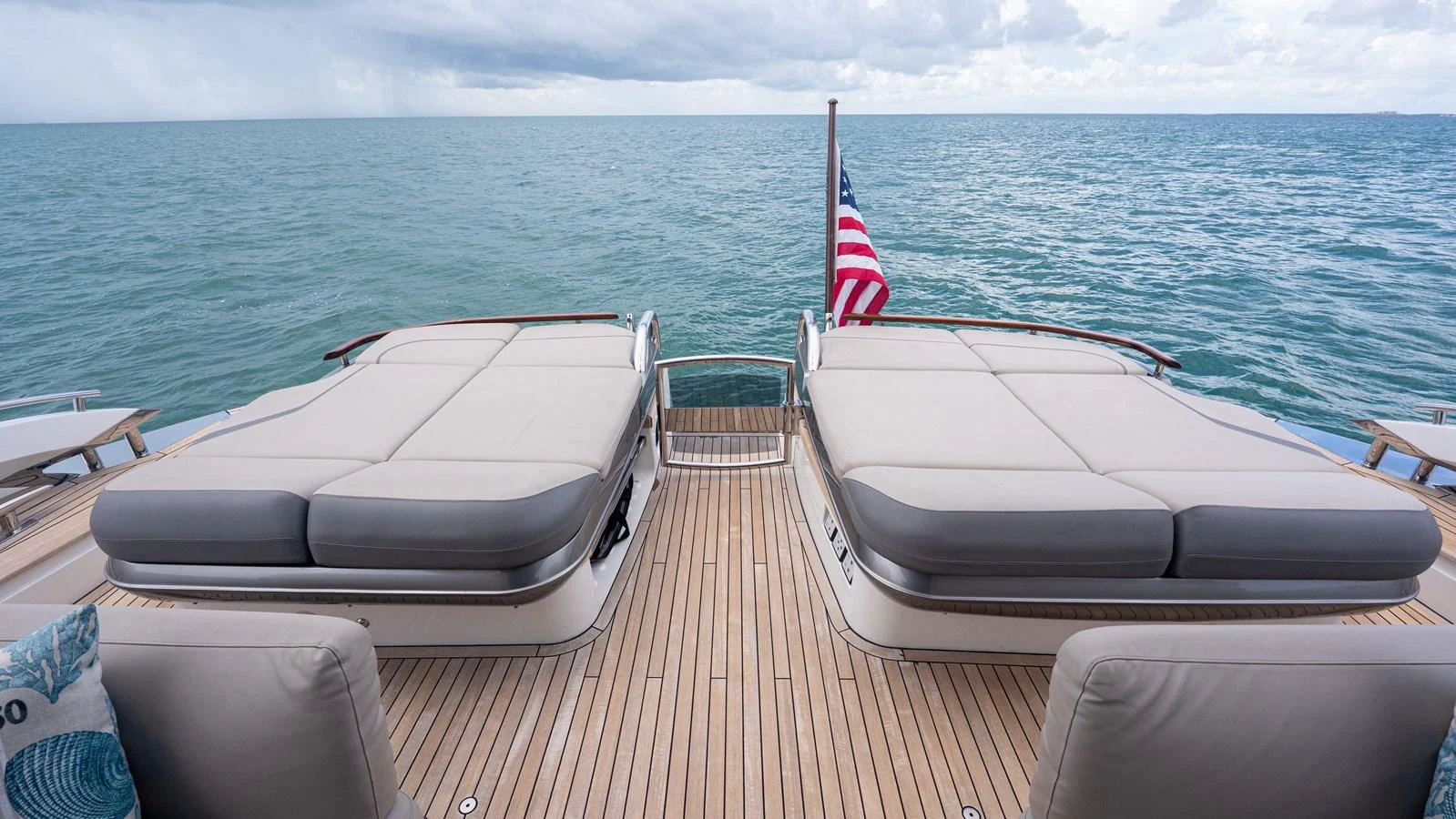 The aft deck features spacious sunbeds with a stunning ocean view. aboard PARAGON Yacht for Sale