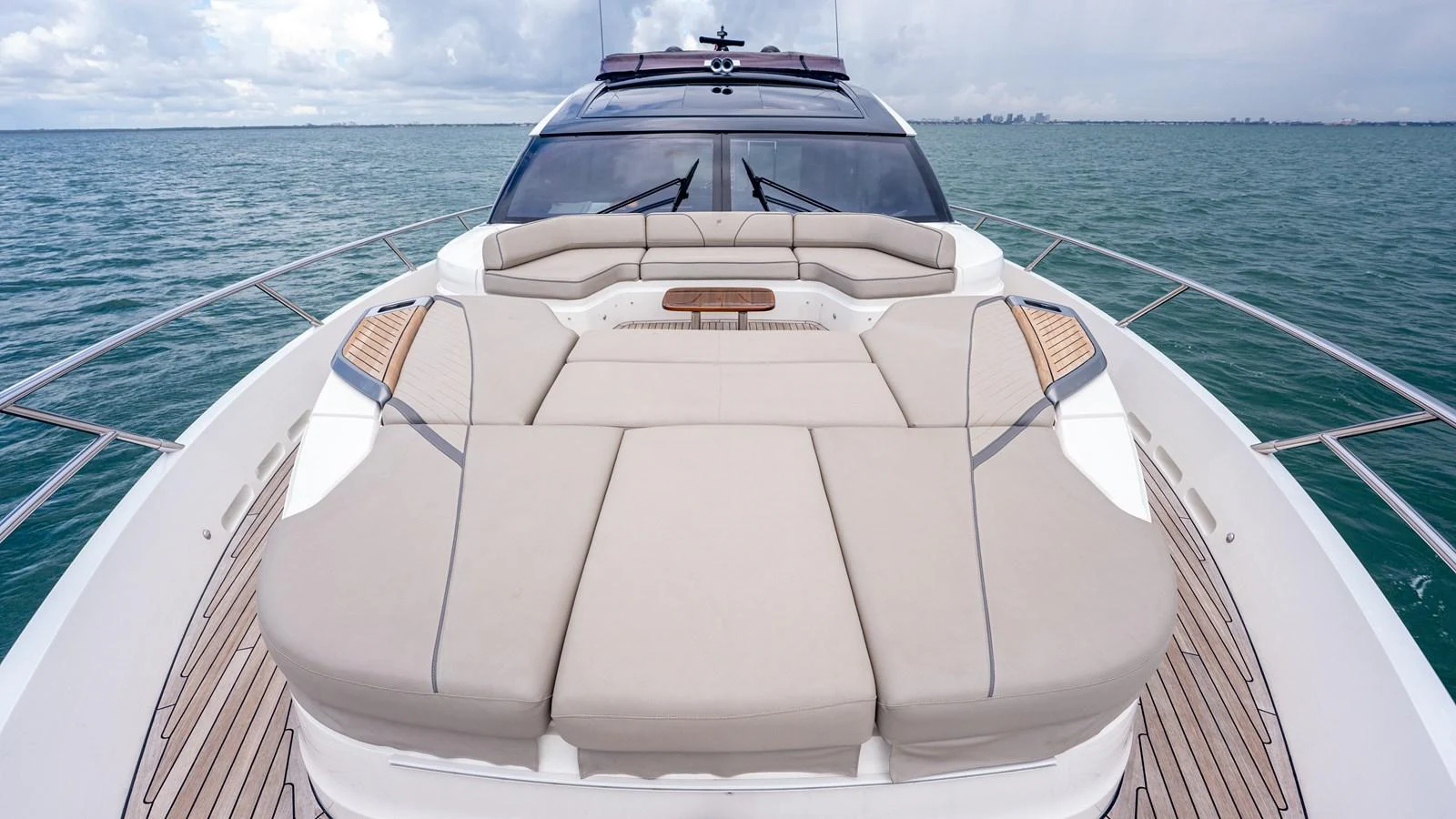 The foredeck features a spacious sunpad area with plush cushions, perfect for relaxation. aboard PARAGON Yacht for Sale