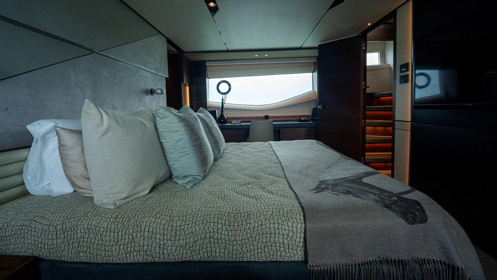 The stateroom features a luxurious bed with plush pillows and modern decor. aboard PARAGON Yacht for Sale