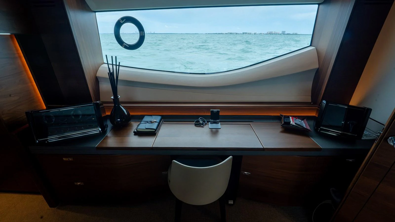 A sleek and modern yacht office with a stunning sea view through a large window. aboard PARAGON Yacht for Sale
